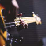 student playing a bass guitar