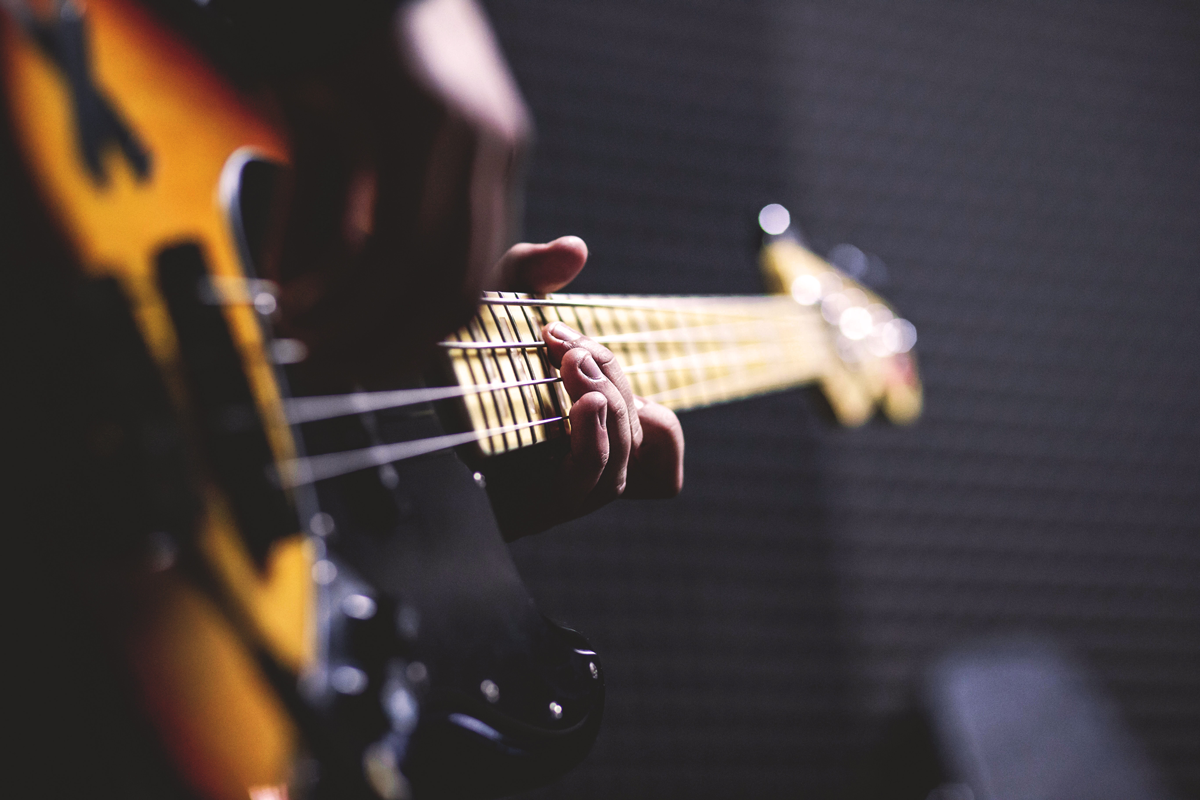 student playing a bass guitar