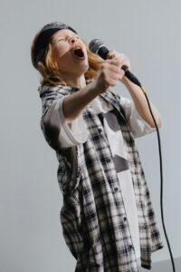 boy singing into microphone